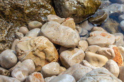 Full frame shot of pebbles in sea