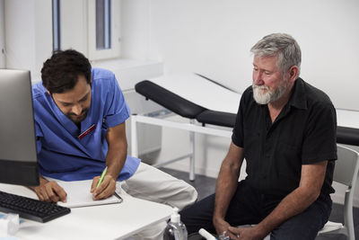 Male doctor and senior patient during appointment