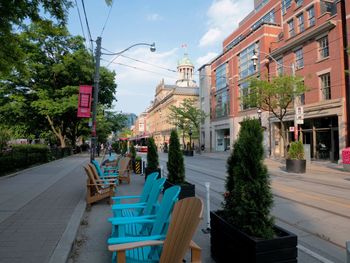 City street and buildings against sky