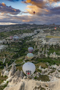  colorful hot air balloons fly at sunrise near goreme, vie from balloon