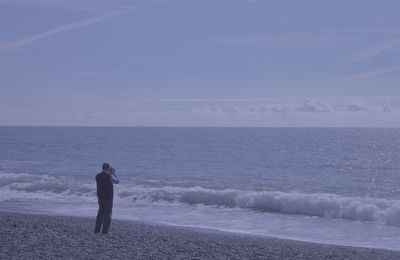 Man looking at sea against sky