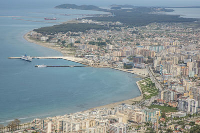 High angle view of sea and buildings in city