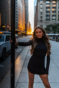 Beautiful young woman on street in city