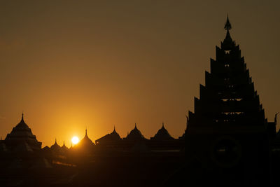 Silhouette of temple against sky during sunset