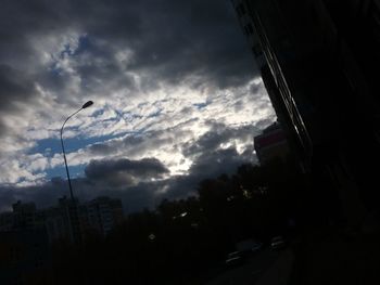 Low angle view of silhouette buildings against sky