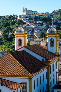 Exterior of illuminated buildings in town against sky