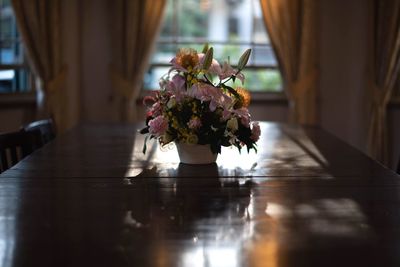 Close-up of flower vase on table at home