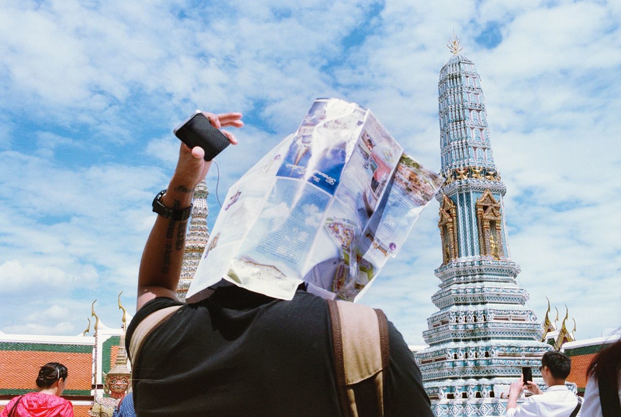 LOW ANGLE VIEW OF WOMAN STANDING AGAINST EIFFEL TOWER