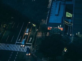 High angle view of illuminated street amidst buildings at night