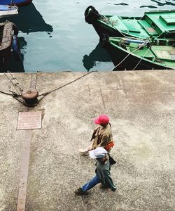 High angle view of people sitting on boat in lake