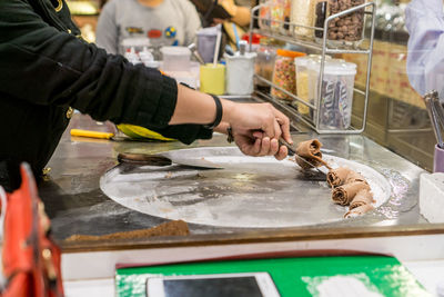 Man preparing food at market stall