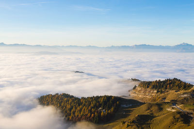 Scenic view of mountain range against cloudy sky