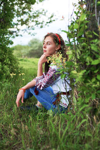 Beautiful caucasian woman in a folk costume in the garden 