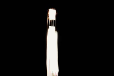 Close-up of illuminated lamp against black background