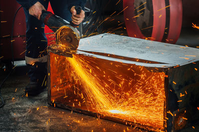 Low angle view of man working on metal