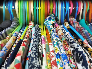 Close-up of multi colored clothes on rack in store