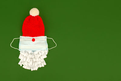 Red and white hat against colored background