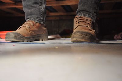 Low section of man wearing shoes on floor