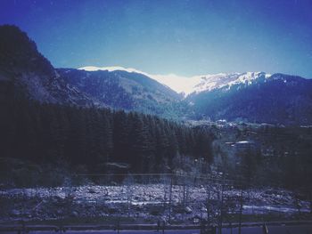 Scenic view of mountains against sky at night