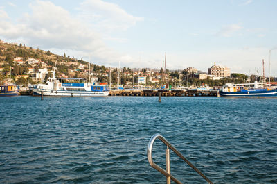 Boats in river with buildings in background