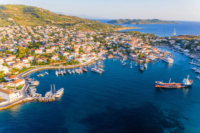 High angle view of townscape by sea against sky