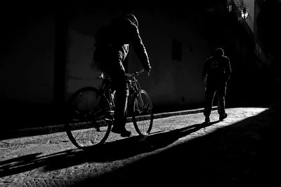 Rear view of people on street at night