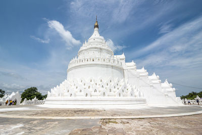 Wide angle shot of limestone pagoda against blue sky