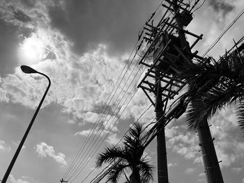 Low angle view of silhouette street light against sky