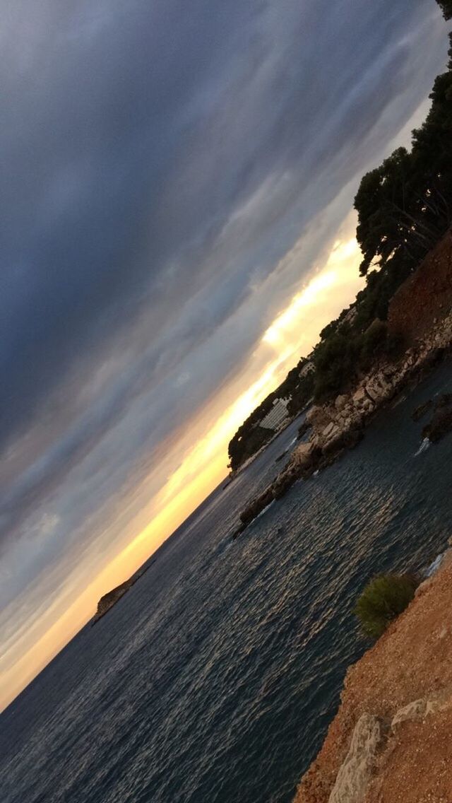 sea, sunset, horizon over water, sky, scenics, tranquil scene, water, beauty in nature, tranquility, cloud - sky, nature, idyllic, shore, orange color, cloud, cloudy, coastline, outdoors, remote, no people, non-urban scene, dramatic sky, calm, majestic, ocean, non urban scene, weather, overcast