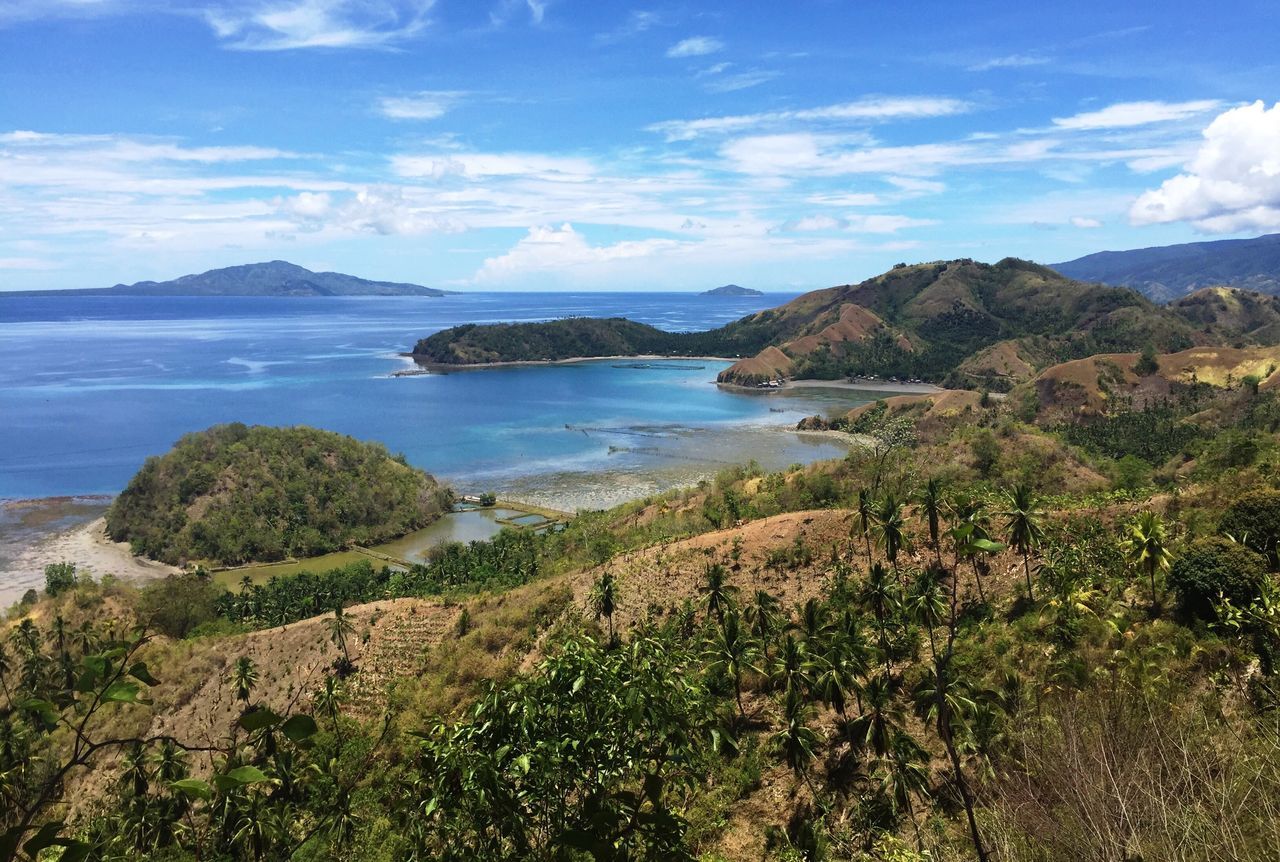 mountain, tranquil scene, sky, tranquility, scenics, water, beauty in nature, sea, mountain range, nature, cloud - sky, cloud, landscape, idyllic, plant, coastline, non-urban scene, lake, grass, blue