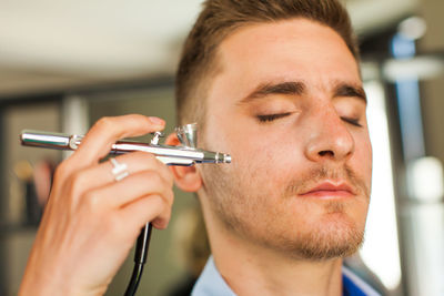 Close-up of man using mobile phone