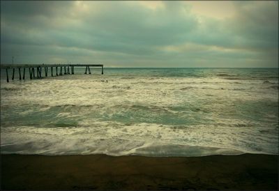 Scenic view of sea against cloudy sky