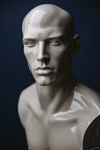 Close-up portrait of mannequin against black background