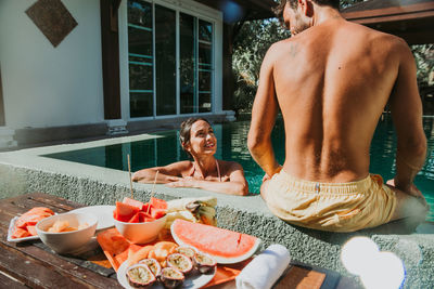 Midsection of man and woman sitting at table