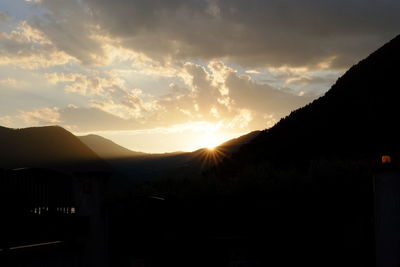 Scenic view of mountains against sky at sunset