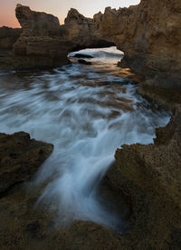 Scenic view of rocks at sea shore