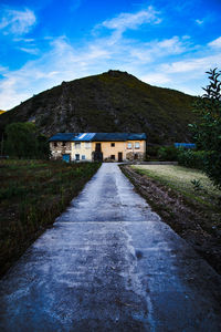 Road amidst old buildings against sky