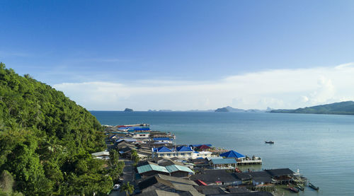 High angle view of sea and buildings against sky