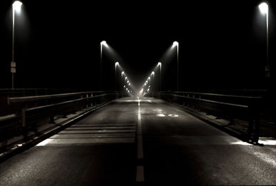 Illuminated bridge at night