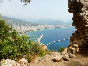 Scenic view of sea and mountains against sky