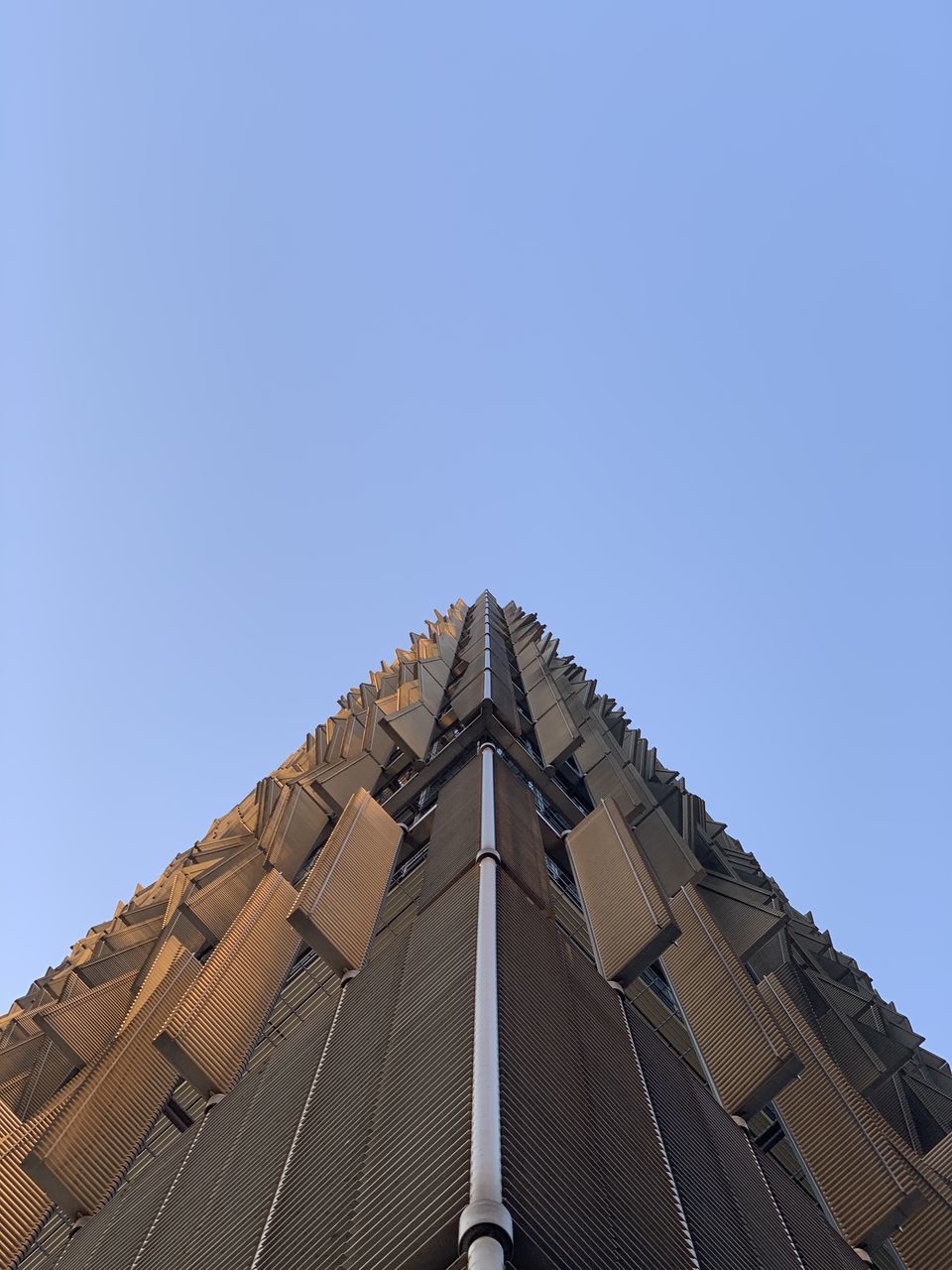 LOW ANGLE VIEW OF BUILDING AGAINST BLUE SKY
