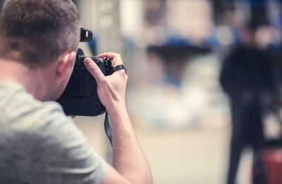 Rear view of man photographing