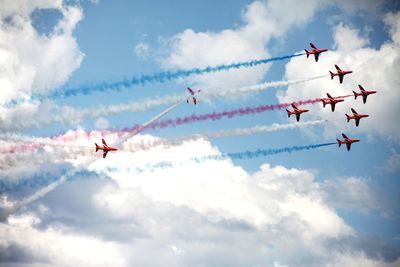 Low angle view of airshow against sky