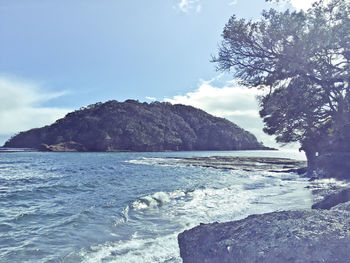 View of calm sea against mountain range