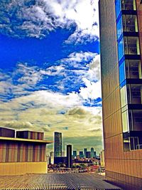 Buildings against cloudy sky