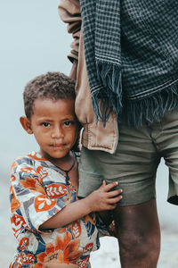 Full length of father with son standing outdoors