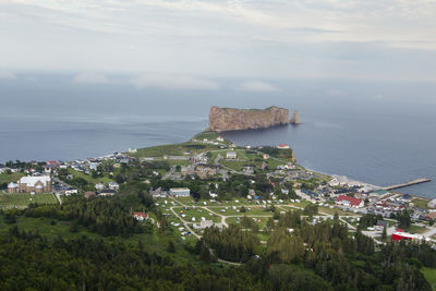 High angle view of townscape by sea against sky