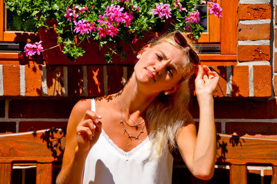 Portrait of beautiful young woman with hands