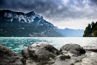 Scenic view of lake and mountains against sky