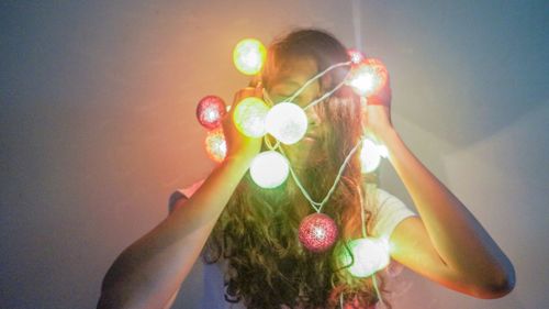 Close-up of hand holding balloons